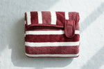 Red striped pet bath robe folded flat showing velcro strap